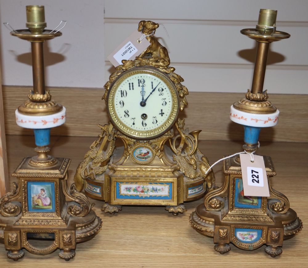A 19th century French Louis XVI style ormolu mantel clock and a pair of associated spelter table lamps,